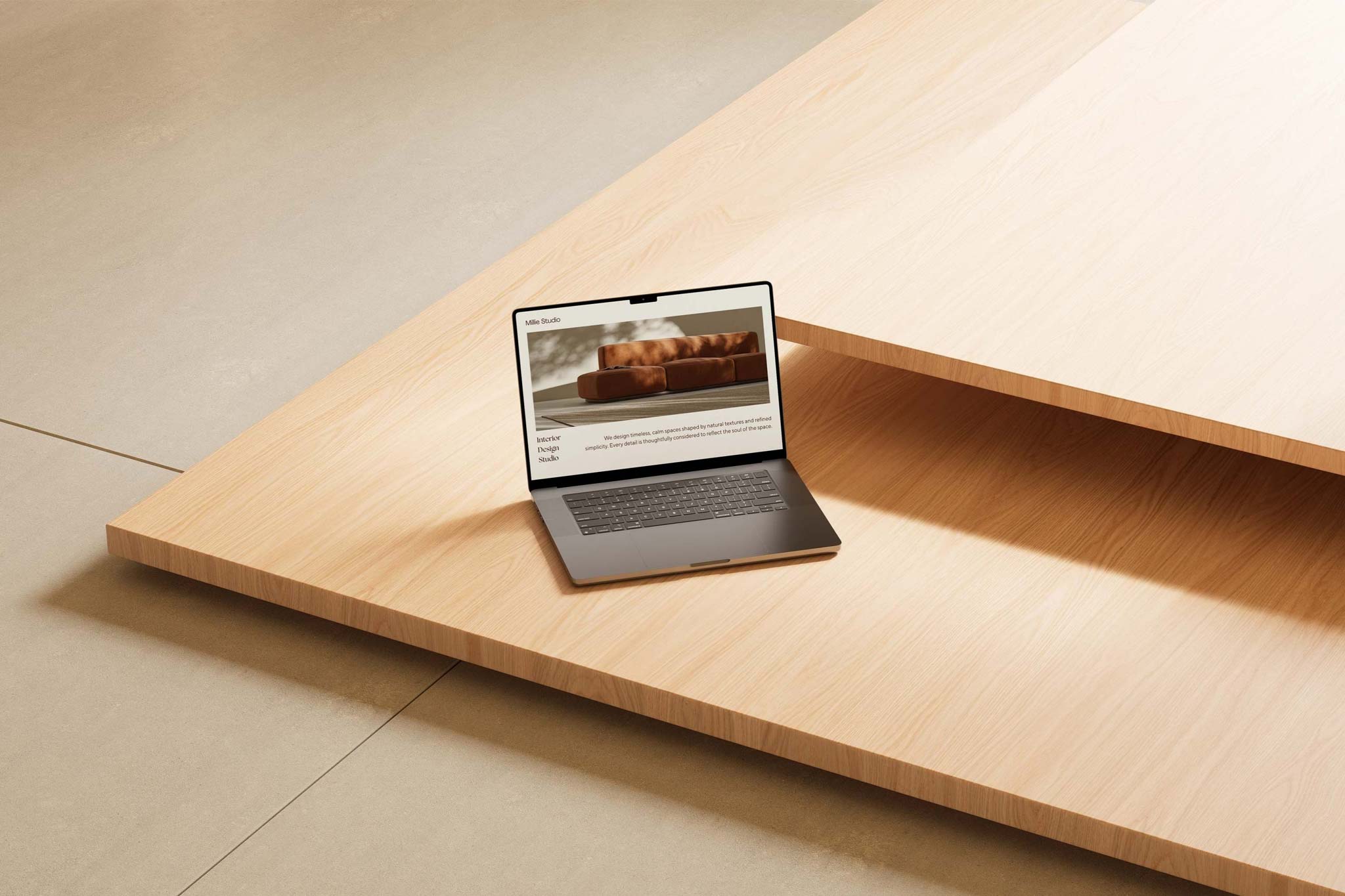 Overhead shot of an open MacBook Pro laptop on a light wood surface with geometric shadows.