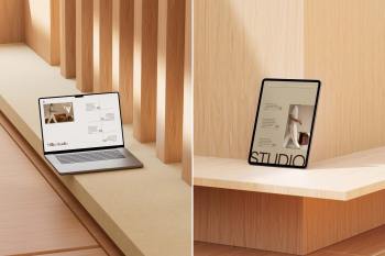 A MacBook Pro on the floor and an iPad Pro standing on a wooden ledge between large wooden pillars