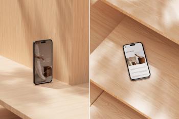 Close-up shot of an iPhone screen mockup resting on light wood joinery with soft daylight.